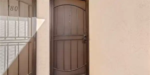 Image 4: View of exterior entry featuring stucco siding