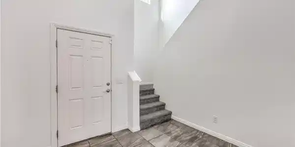 Image 3: High ceilings and polished tile flooring elevate t
