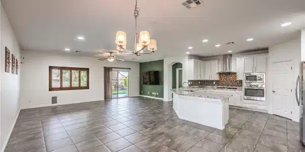 Image 4: An open-concept living area flows seamlessly into