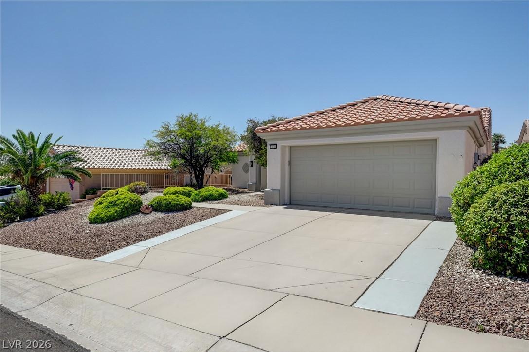 Image 3: A well-maintained facade with an attached garage o