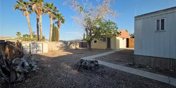 Image 3: A spacious backyard with a convenient storage shed