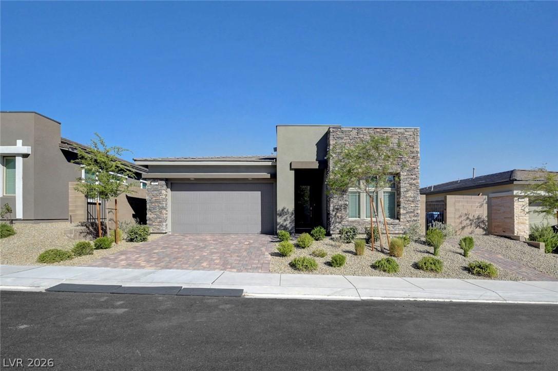 Image 1: Modern desert landscaping and a paver driveway enh