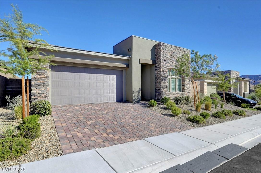 Image 2: A well-maintained front yard offers lush landscapi