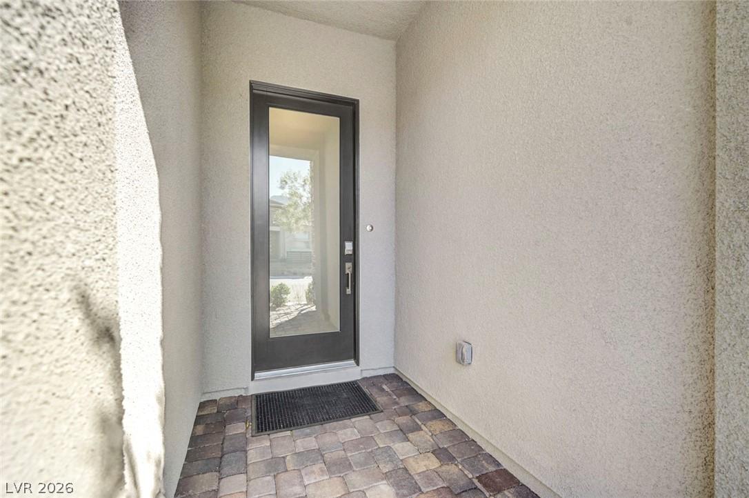 Image 4: A welcoming entry features a sleek glass-paneled d