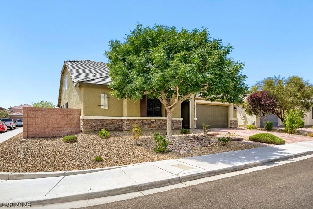 Image 3: A well-kept front yard showcases desert landscapin