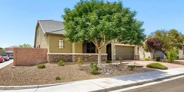 Image 3: A well-kept front yard showcases desert landscapin