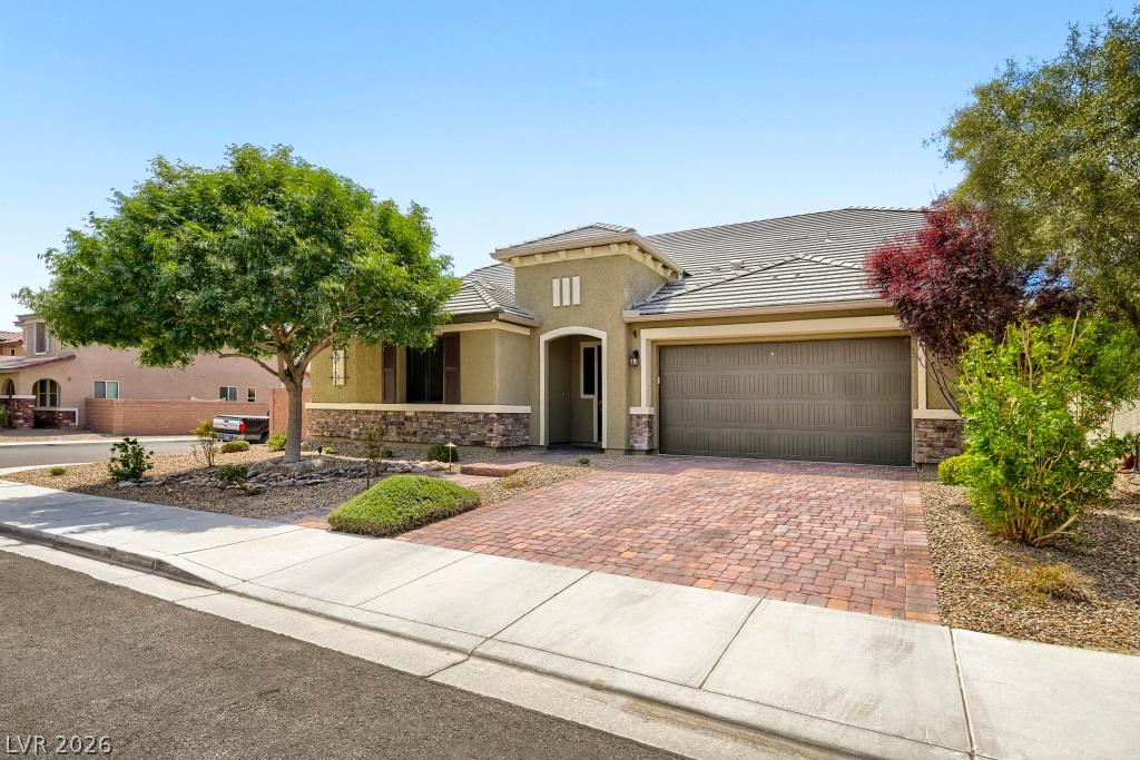 Image 4: A well-kept front yard and brick driveway lead to