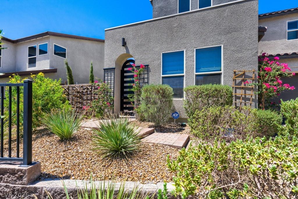 Image 3: Private gated front courtyard surrounded by mature