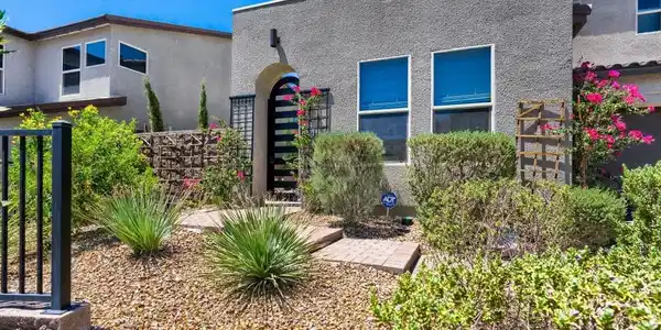 Image 3: Private gated front courtyard surrounded by mature