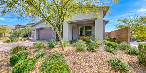 Image 2: Desert landscaping and stone accents frame the ent