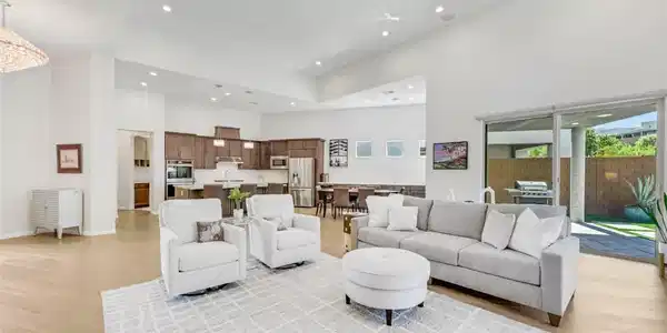 Image 3: Soaring ceilings, warm wood flooring, a sleek mode