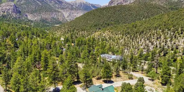 Image 2: A tranquil mountain retreat awaits, nestled amidst