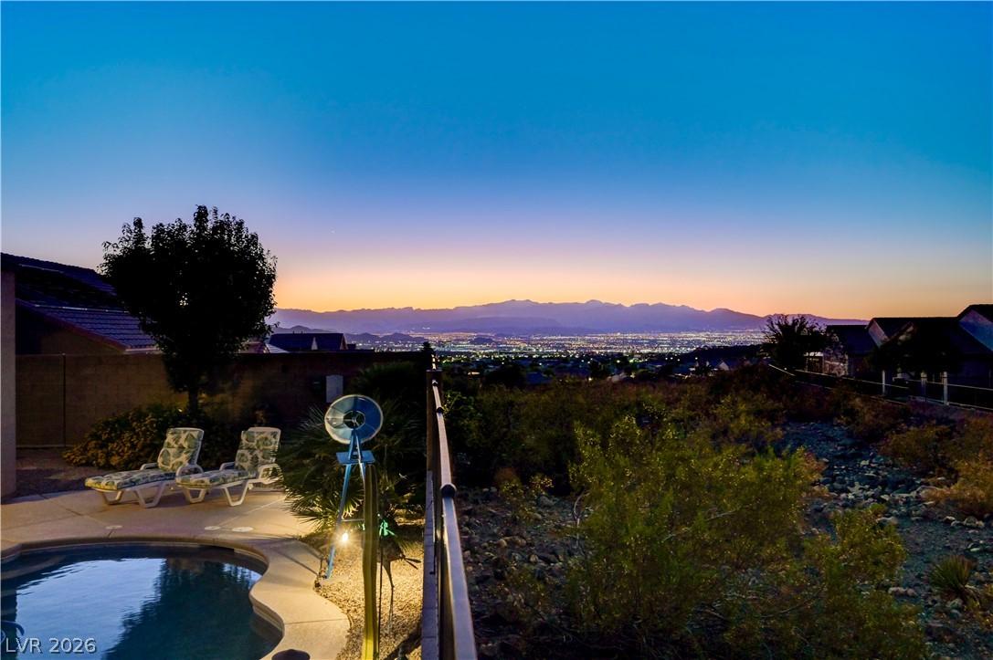 Image 3: City lights twinkle across the desert landscape, f