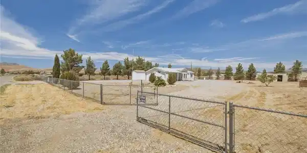 Image 3: A well-maintained perimeter fence encloses a spaci