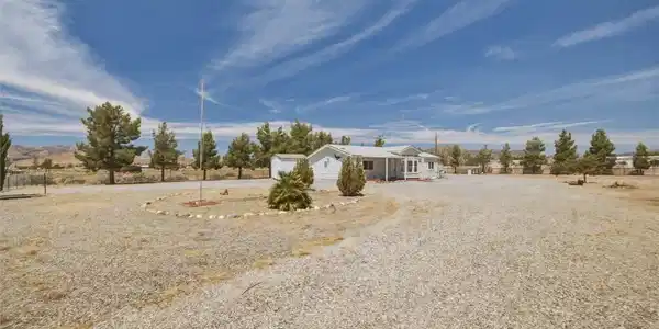 Image 4: An inviting gravel driveway circles before a charm