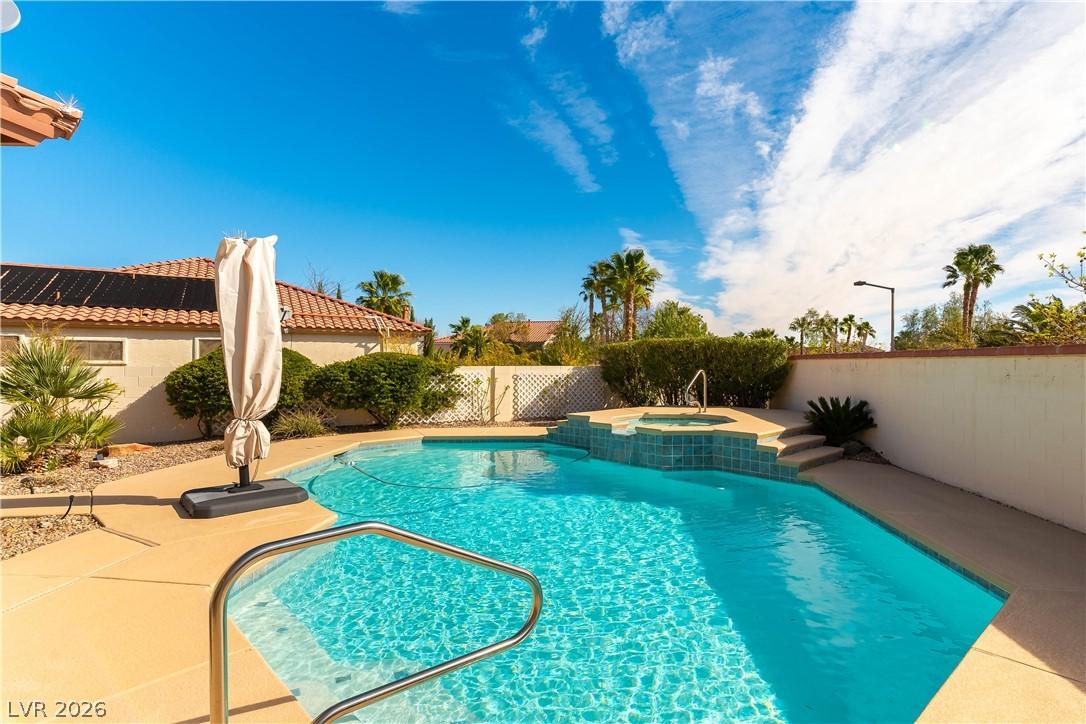 Image 2: A refreshing pool and spa area creates an outdoor