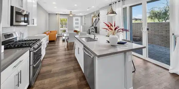 Image 2: A spacious kitchen flows seamlessly into the dinin