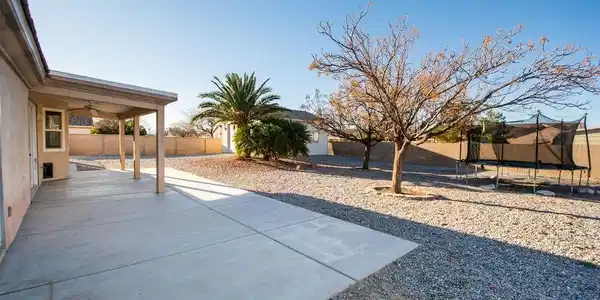 Image 3: View of front facade with stone siding, concrete d