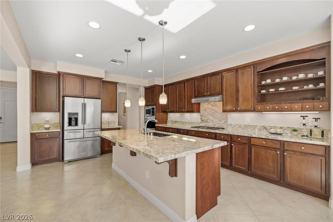 Image 3: A well-appointed kitchen features rich wood cabine