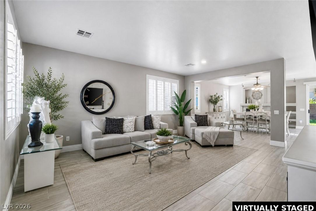 Image 2: Natural light pours into this bright living area,