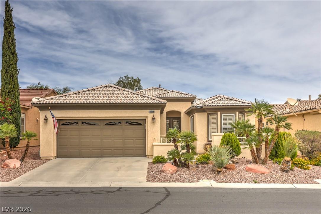 Image 1: A well-maintained stucco home with a tile roof and