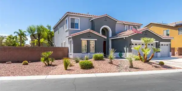 Image 3: A classic Spanish tile roof accents this two-story