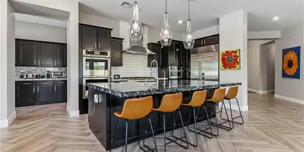 Image 3: This kitchen features a spacious island, sleek app