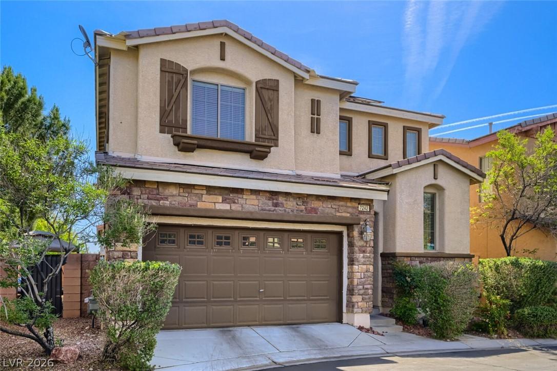 Image 2: This house features a classic design with stone an