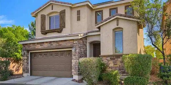 Image 3: This two-story residence presents a classic exteri