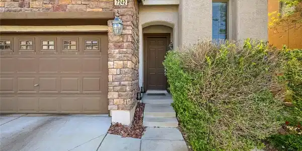 Image 4: This inviting home facade features a seamless blen