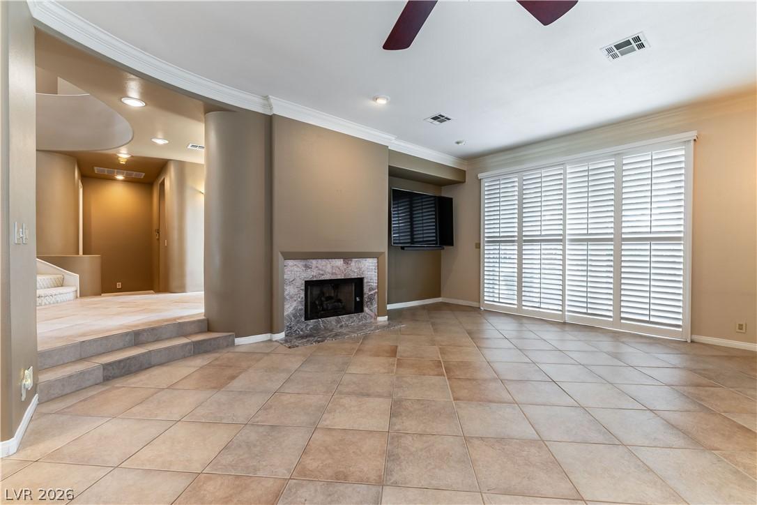 Image 4: A spacious living area with tile flooring and a ma