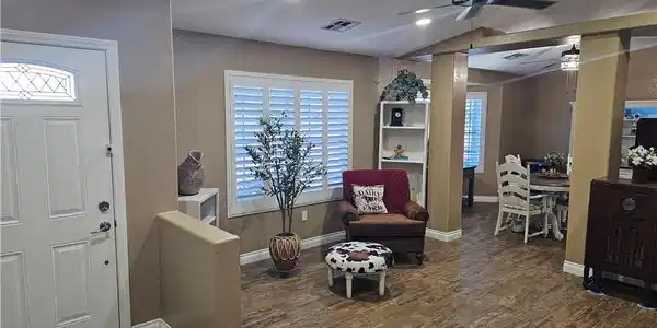 Image 3: Natural light illuminates rich wood-look flooring