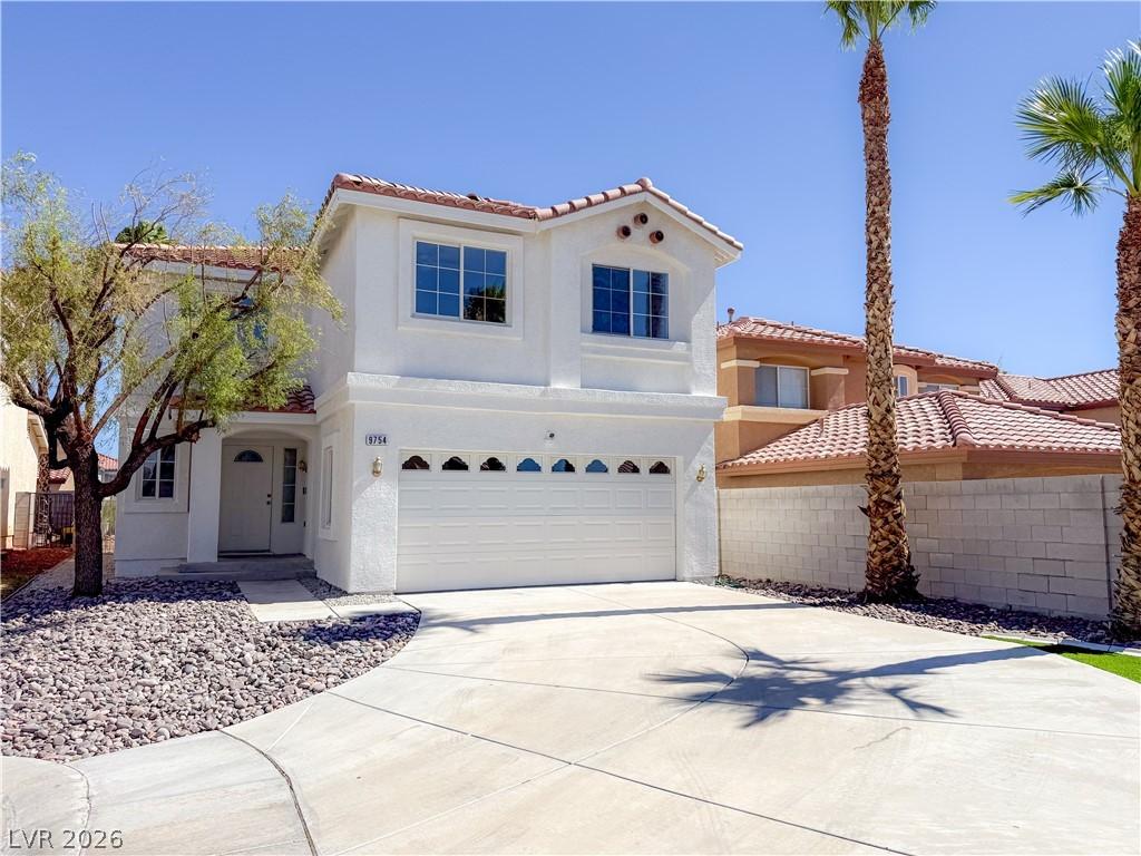 Image 3: A well-maintained stucco home with a tile roof off