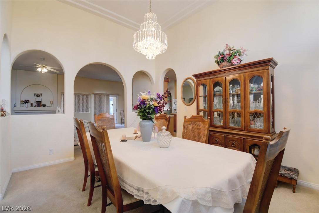 Image 4: Ornate crystal chandelier and archways define this