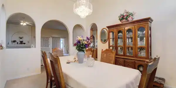 Image 4: Ornate crystal chandelier and archways define this