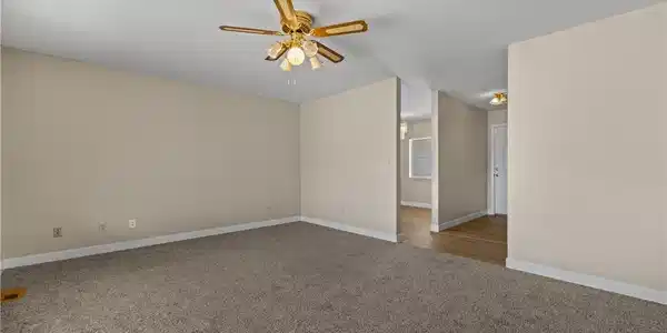 Image 4: Plush carpeting and an open-concept flow connect t