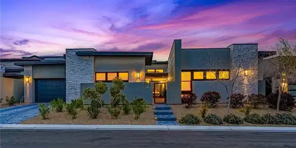 Image 2: View of front of house featuring stone siding, a g