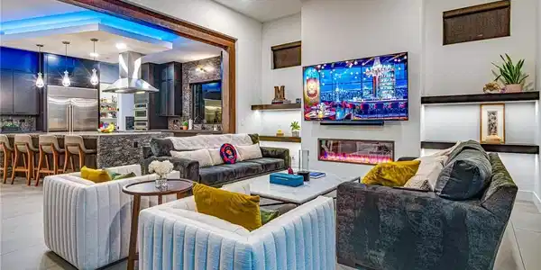 Image 4: Living area featuring a glass covered fireplace, l