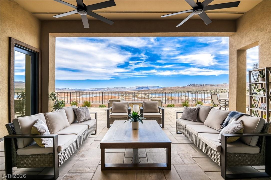 Image 1: An inviting covered patio with an impressive lake
