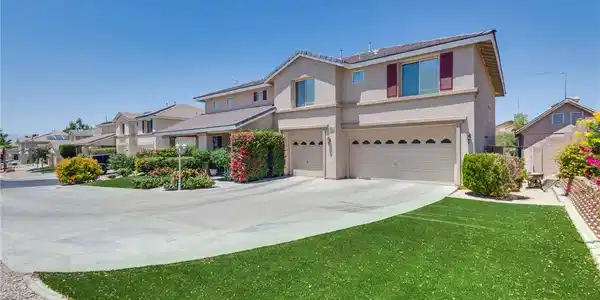 Image 4: Manicured landscaping and a long driveway welcome