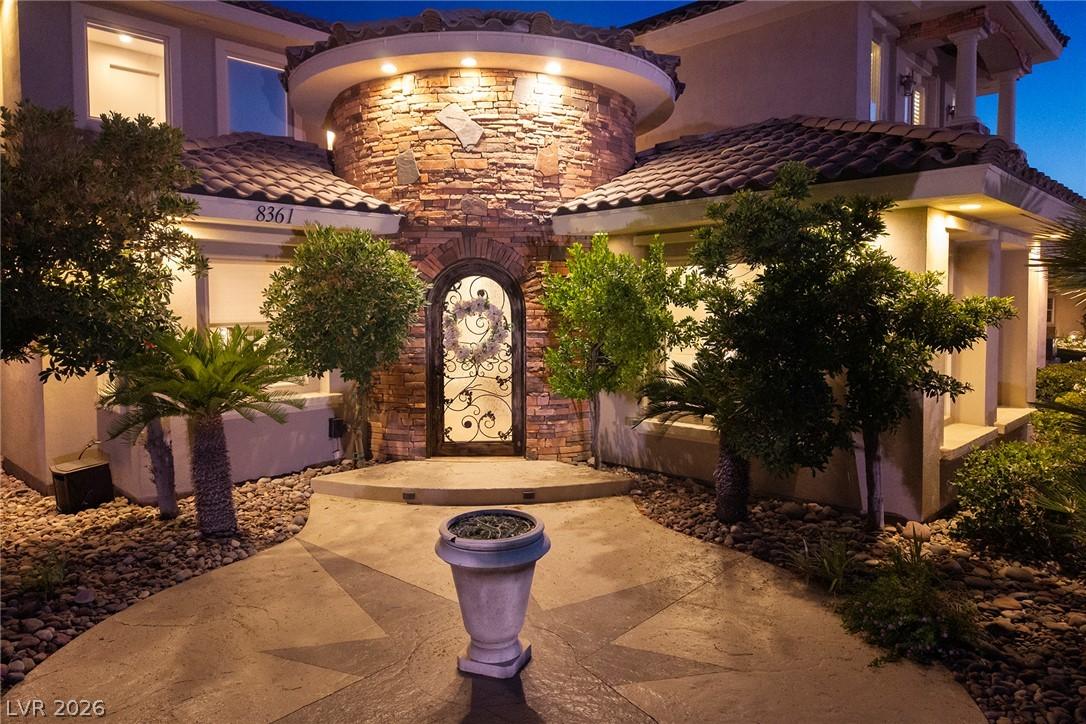 Image 4: A grand entrance with custom ironwork and stone-cl