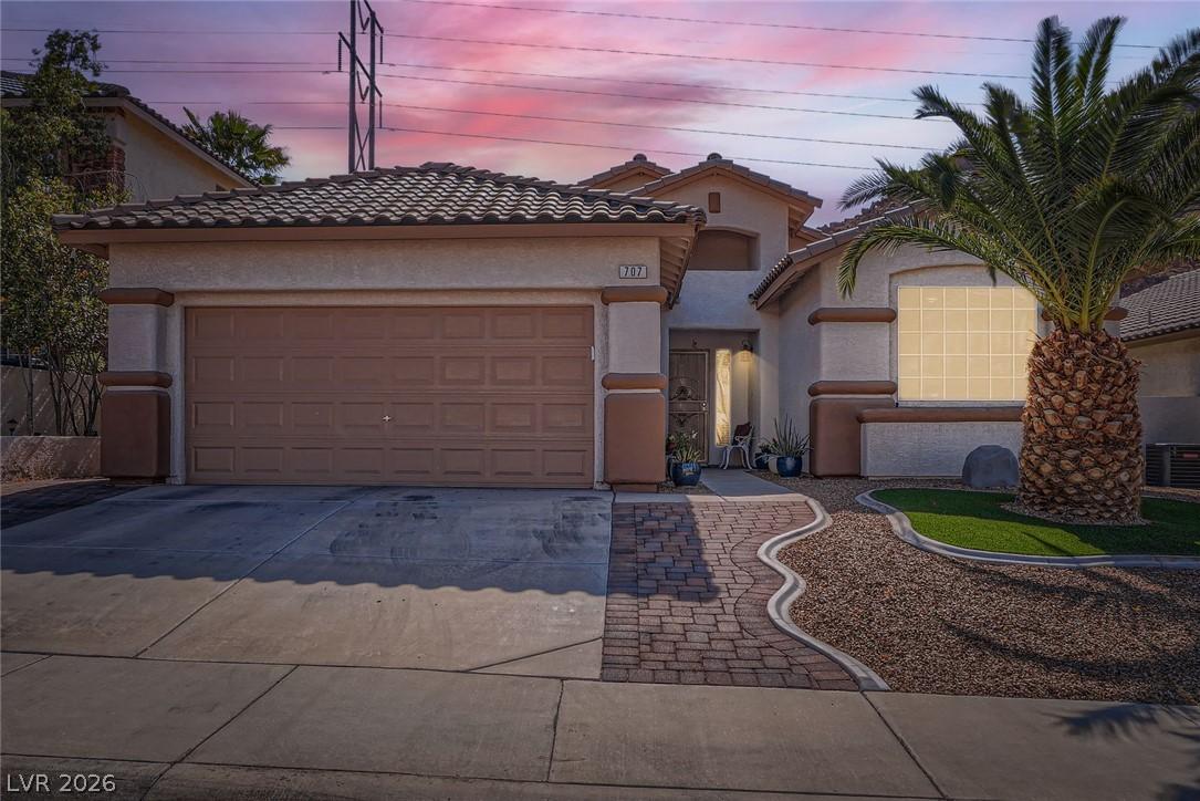Image 1: A desert oasis welcomes you home with a paver walk