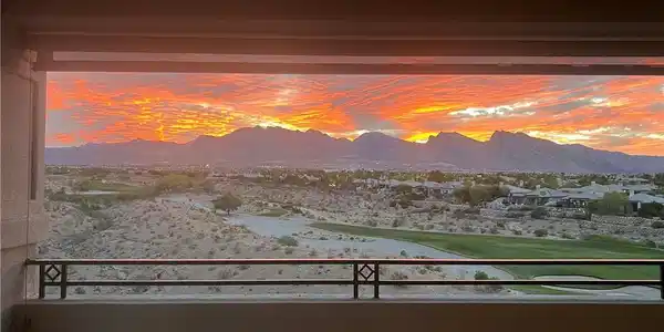 Image 3: A vibrant sunset over majestic mountains and a gol