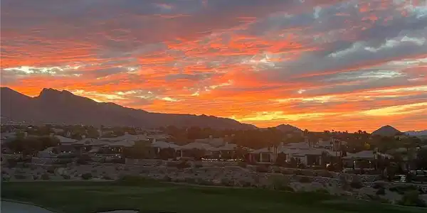 Image 4: Golden hour glows over a golf course, framing a co