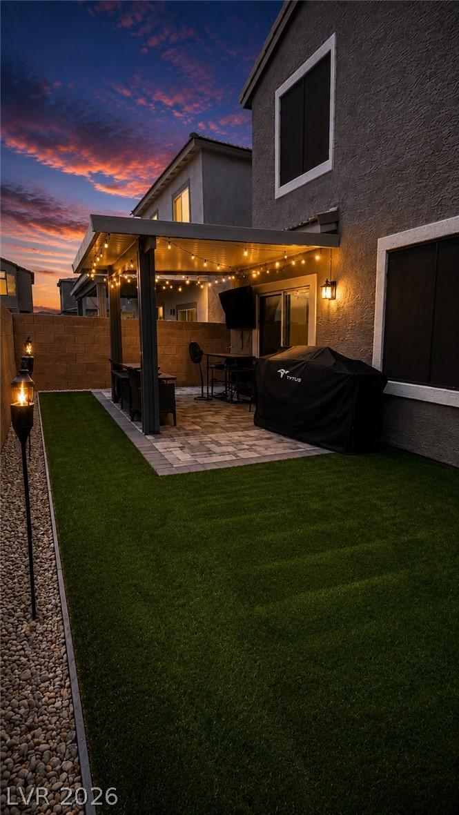 Image 4: An inviting paved patio with festive string lights