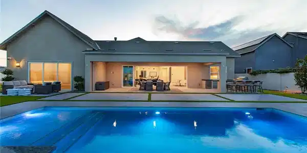 Image 2: A sparkling swimming pool anchors the expansive ba