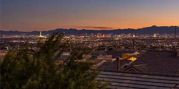 Image 2: Distant city lights and rugged mountain ridges def