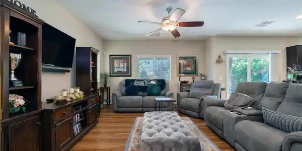 Image 3: Rich wood flooring anchors this comfortable living