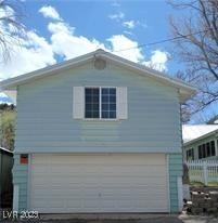 Image 4: View of property exterior with an attached garage