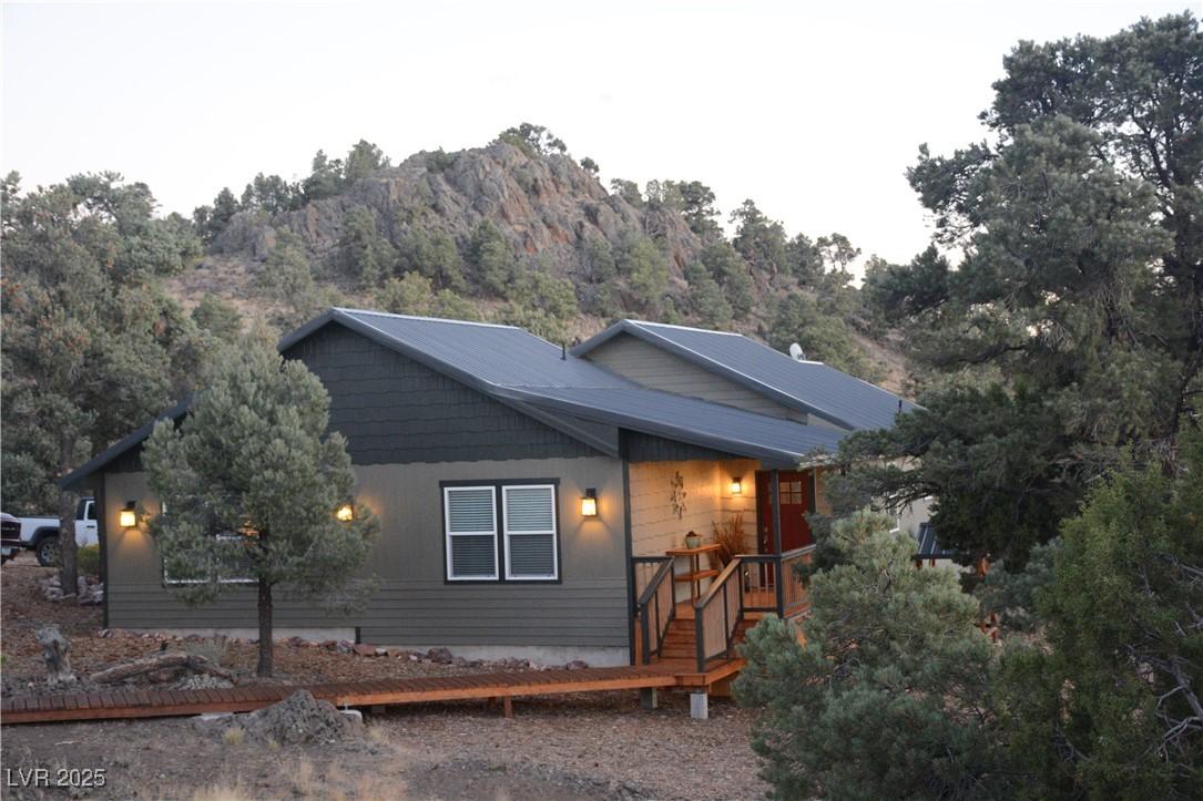 Image 1: View of front of house featuring a deck with mount